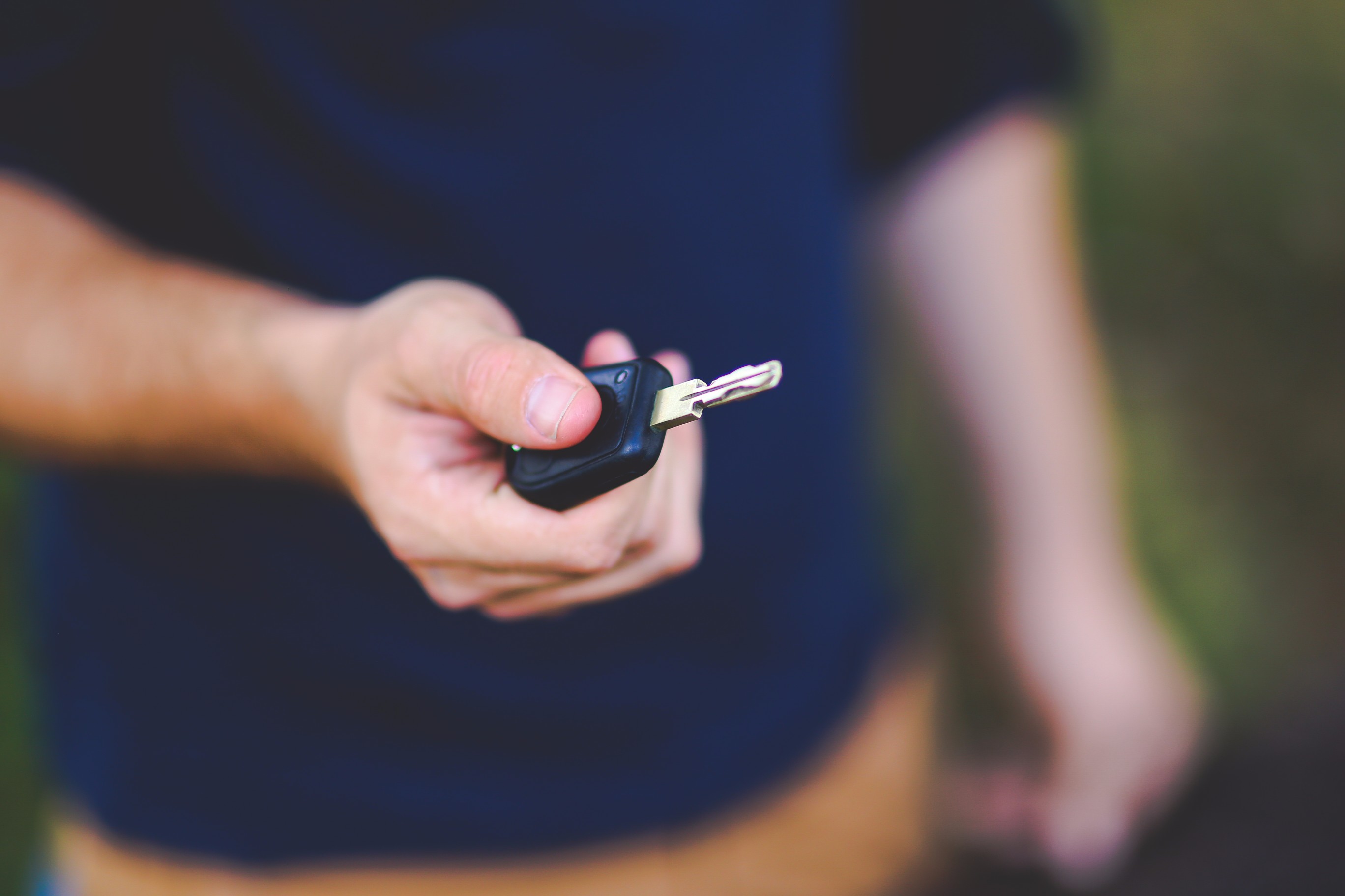 Person holding car key - How to sell a car that needs work - Cars Brisbane