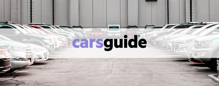 carsguide logo over parked cars